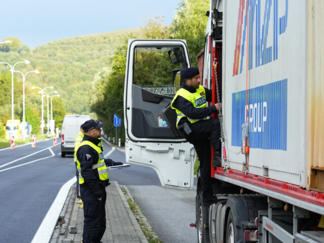 Czech policemen control a truck at the border with Slovakia in Stary Hrozenkov, Czech Repu