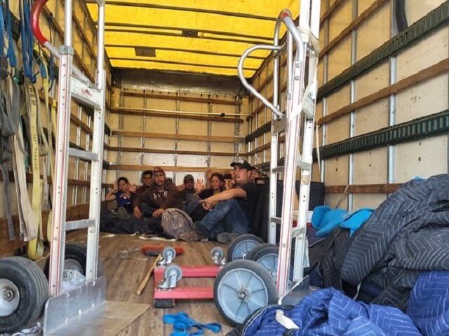 Agents find a group of ten migrants locked inside a moving-company box truck. (U.S. Border