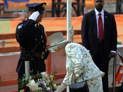 Queen Elizabeth II of England lays a wreath as she pays tribute to the victims of the 9/11 attacks during a visit to Ground Zero in Nwew York July 6, 2010. AFP PHOTO/TIMOTHY A. CLARY (Photo credit should read TIMOTHY A. CLARY/AFP via Getty Images)