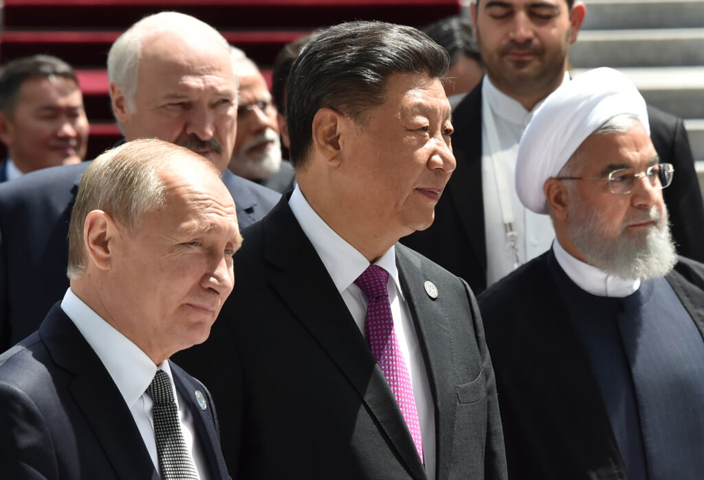 Russian President Vladimir Putin, Chinese President Xi Jinping and Iran's President Hassan Rouhani walk as they attend a meeting of the Shanghai Cooperation Organisation (SCO) Council of Heads of State in Bishkek on June 14, 2019. (Photo by Vyacheslav OSELEDKO / AFP) (Photo credit should read VYACHESLAV OSELEDKO/AFP via Getty Images)