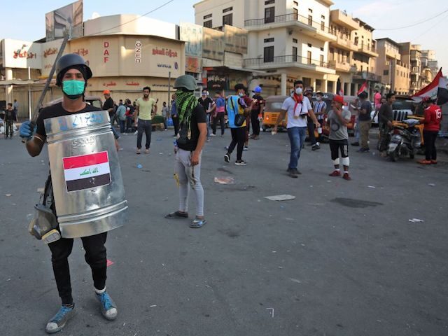 A picture taken on November 7, 2019, shows an Iraqi demonstrator using protective gear ami