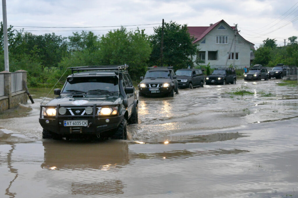 LANCHYN, UKRAINE - JUNE 25, 2020 - A motorcade of President of Ukraine Volodymyr Zelenskyy who is on an urgent working trip to Ivano-Frankivsk Region moves along a flooded street in Lanchyn urban-type settlement, Ivano-Franivsk Region, western Ukraine. As reported, 285 settlements, 9,994 houses, 500 km of roads, 135 bridges and 280m of dams were damaged. - PHOTOGRAPH BY Ukrinform / Future Publishing (Photo credit should read MARKIIAN LYSEIKO/ Ukrinform/Future Publishing via Getty Images)