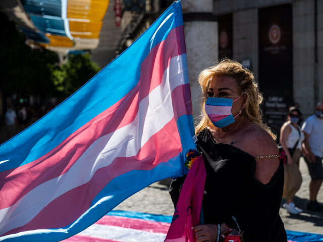 MADRID, SPAIN - 2020/07/04: Demonstrator with the Trans flag attends a protest where Trans community demand a state law that will guarantee gender self-determination. The protest coincides with the Pride celebrations that are taking place this week. (Photo by Marcos del Mazo/LightRocket via Getty Images)