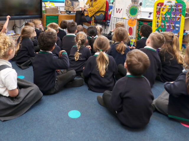 The reception class at Manor Park School and Nursery in Knutsford, Cheshire, listen to a story read by teacher Mrs Power, at the start of a four week national lockdown for England. (Photo by Martin Rickett/PA Images via Getty Images)