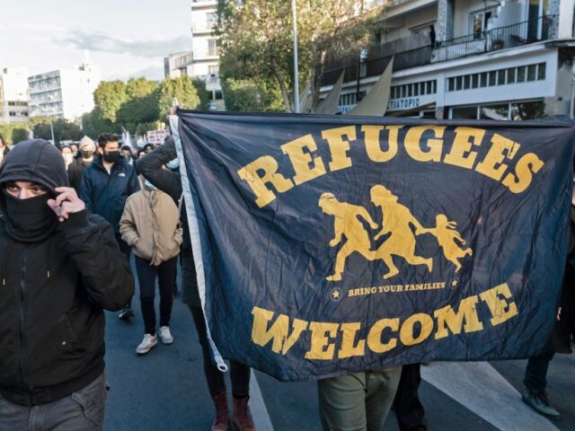 Demonstrators carry a banner for refugees as they march against corruption in the Cypriot