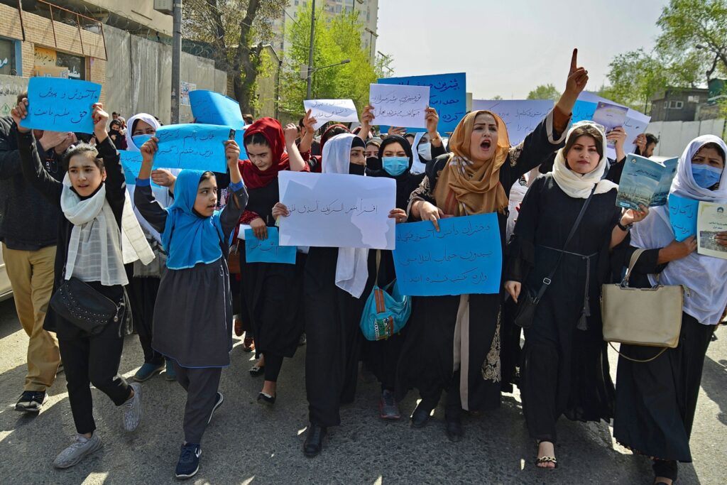 Afghan women and girls take part in a protest in front of the Ministry of Education in Kabul on March 26, 2022, demanding that high schools be reopened for girls. (Photo by Ahmad SAHEL ARMAN / AFP) (Photo by AHMAD SAHEL ARMAN/AFP via Getty Images)