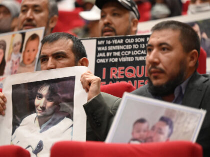 Members of Muslim Uyghur minority present pictures of their relatives detained in China during a press conference in Istanbul, on May 10, 2022. - Turkey's Uyghur community urged UN human rights chief to probe so-called "re-education camps" during a long-delayed visit to China this month including to Xingjiang, where Western …