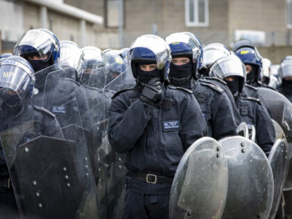 MET Police officers taking part in Public Order training dressed in full riot uniform with