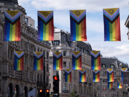 Intersex Inclusive Pride flags high above Regent Street in advance of the Pride in London parade on 28th June 2022 in London, United Kingdom. The flag includes stripes to represent LGBTQ+ communities, with colors from the Transgender Pride Flag, alongside the and circle of the Intersex flag. (photo by Mike …