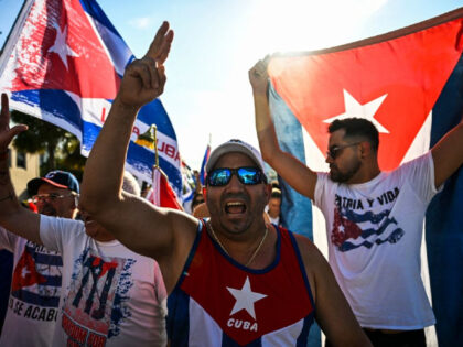 People shout slogans as they march through the streets of Miami, Florida, to commemorate last year's historic protests in Cuba, on July 11, 2022. - Hundreds of members of Miami's Cuban community took to the streets on July 11 in the US city to commemorate the historic protests held a …