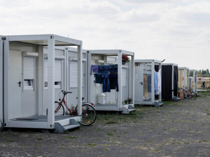 Laundry hangs under the entrance porch and bycicles lean on them by the container-accommodations at the former Tempelhof Airport in Berlin, Germany, on August 8, 2022. (Photo by Carsten Koall / AFP) (Photo by CARSTEN KOALL/AFP via Getty Images)