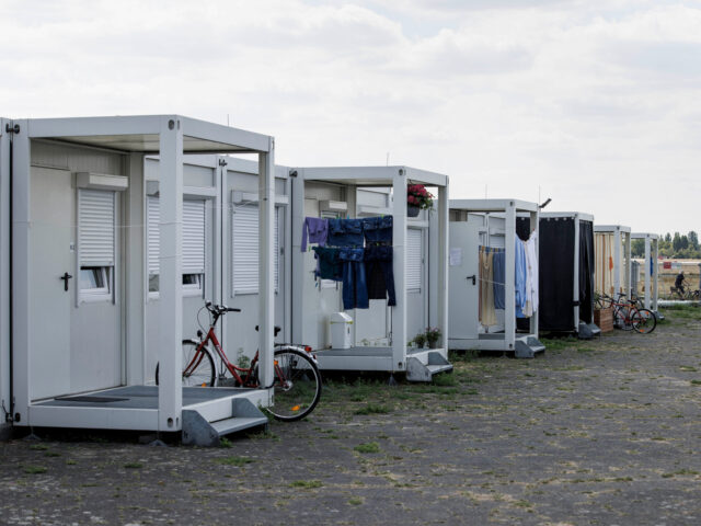 Laundry hangs under the entrance porch and bycicles lean on them by the container-accommod