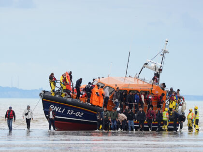 A group of people thought to be migrants are brought in to Dover, Kent, by the RNLI, follo