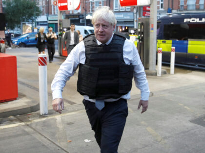 LONDON, ENGLAND - AUGUST 31: British Prime Minister Boris Johnson walks away from an area following a drug-related raid on a property by Metropolitan Police officers on August 31, 2022 in London, England. British Prime Minister Boris Johnson is visiting South London and Milton Keynes on his farewell tour. (Photo …
