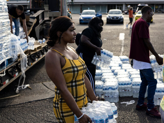 JACKSON, MS - AUGUST 31: Aelicia Hodge (C) helps hand out cases of bottled water at a Miss
