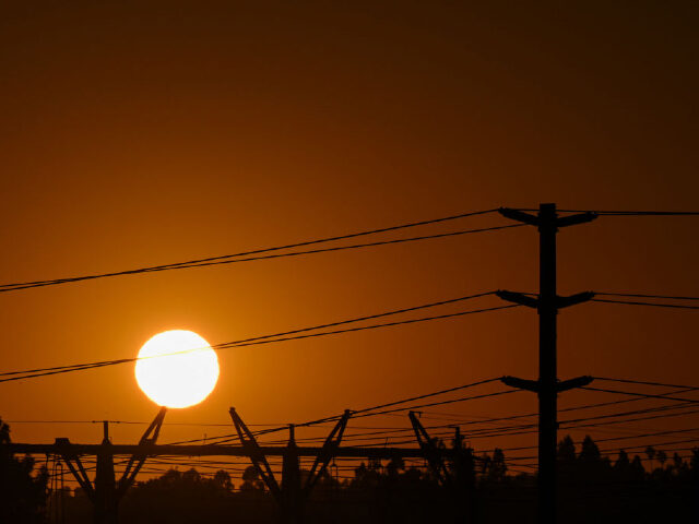 The sun sets behind electric power lines as the California Independent System Operator announced a statewide electricity Flex Alert urging conservation to avoid blackouts in Redondo Beach, California on August 31, 2022. - Californians were told August 31, 2022 not to charge their electric vehicles during peak hours, just days …