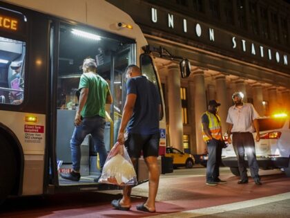 A group of migrants board a CTA bus at Chicago's Union Station to be taken to a Salvation