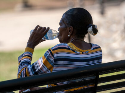 A resident drinks water during a heatwave in Sacramento, California, US, on Tuesday, Sept. 6, 2022. California narrowly avoided blackouts for a second successive day even as blistering temperatures pushed electricity demand to a record and stretched the state's power grid close to its limits. Photographer: David Paul Morris/Bloomberg via …