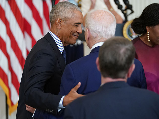 Former US President Barack Obama embraces US President Joe Biden following remarks by former US First Lady Michelle Obama (R), during a ceremony to unveil the Obama's official White House portraits in the East Room of the White House in Washington, DC, on September 7, 2022. (Photo by Mandel NGAN …