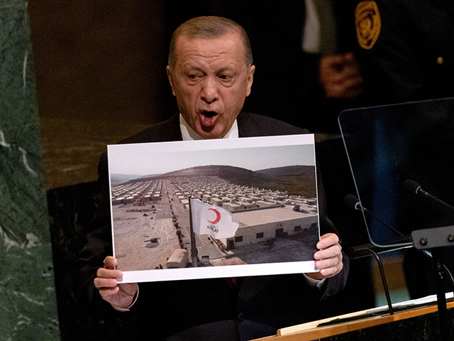 Turkish President Recep Tayyip Erdogan holds a photo of a Syrian refugee camp while addressing the 77th session of the United Nations General Assembly at UN headquarters in New York City on September 20, 2022. (Photo by Yuki IWAMURA / AFP) (Photo by YUKI IWAMURA/AFP via Getty Images)
