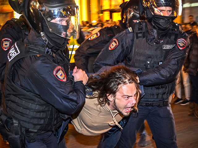 Police officers detain a man following calls to protest against partial mobilisation announced by Russian President, in Moscow, on September 21, 2022. - More than 1,300 people have been arrested at demonstrations across Russia against President Vladimir Putin's announcement of a partial mobilisation of civilians to fight in Ukraine, a …