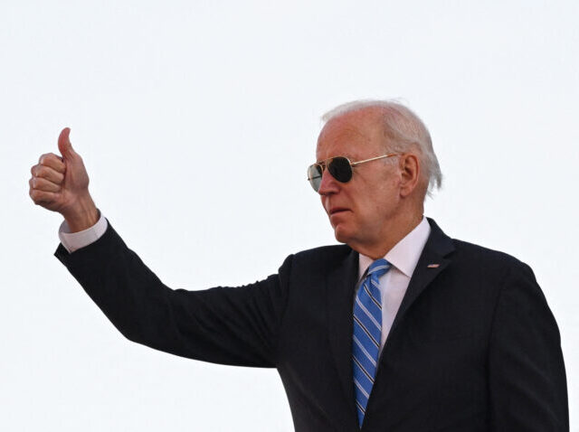 TOPSHOT - US President Joe Biden gives a thumb's up as he boards Air Force One at Joh