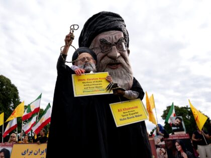 Demonstrators dressed as Iranian President Ebrahim Raisi and Irans Supreme Leader Ali Khamenei rally outside the White House in Washington, DC, on September 24, 2022. - Iran has been rocked by street violence since the death last week of Mahsa Amini, a 22-year-old Kurd who had spent three days in …