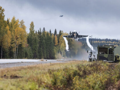 A Boeing F18 Hornet twin-engined multi-role fighter jet using highway four as a runway during the Finnish Air Force Academy's Baana 22 exercise in Joutsa, Finland, Wednesday, Sept. 28, 2022. Officials guarding Finland's 1,300-kilometer (800-mile) border with Russia are calling for a fence to help prevent potential uncontrolled mass-scale entry …