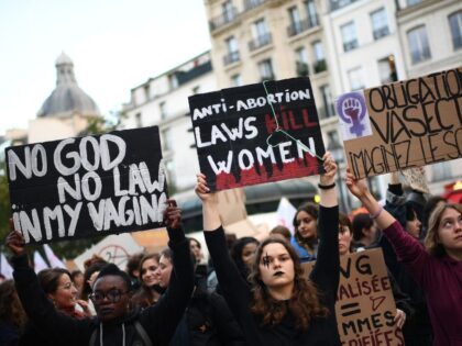 Demonstrators hold placards as they take part in an abortion rights rally on the annual In