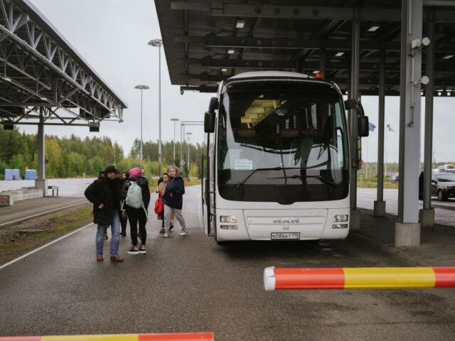 Passengers get off from a bus at the border checkpoint crossing in Vaalimaa, Finland, on t