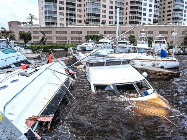 Boats are partially submerged at a marina in the aftermath of Hurricane Ian in Fort Myers, Florida, on September 29, 2022. - Hurricane Ian left much of coastal southwest Florida in darkness early on Thursday, bringing "catastrophic" flooding that left officials readying a huge emergency response to a storm of …