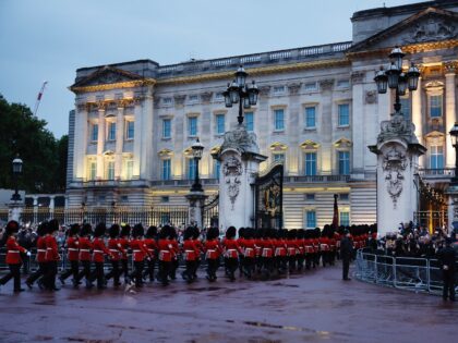 LONDON, UNITED KINGDOM - SEPTEMBER 13: Guardsmen in bearskin hats march through the center gates of Buckingham Palace before the arrival of Queen Elizabeth II's coffin on September 13, 2022 in London, United Kingdom. The coffin carrying Her Majesty Queen Elizabeth II leaves St Giles Church traveling to Edinburgh Airport …