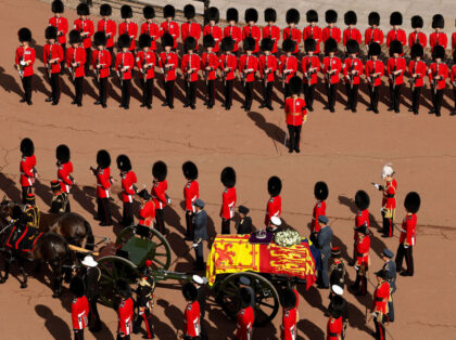 LONDON, ENGLAND - SEPTEMBER 14: Queen Elizabeth II's flag-draped coffin is taken in procession on a Gun Carriage of The King's Troop Royal Horse Artillery from Buckingham Palace to Westminster Hall on September 14, 2022 in London, England. The queen will lay in state until the early morning of her …