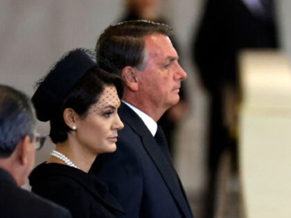 LONDON, ENGLAND - SEPTEMBER 18: President Jair Bolsonaro of Brazil and his wife Michelle Bolsonaro pay their respects to Queen Elizabeth II's flag-draped coffin lying in state on the catafalque at Westminster Hall on September 18, 2022 in London, England. Members of the public are able to pay respects to …