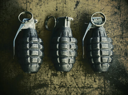 3 hand grenade (pineapple style) on scratchy rusty background