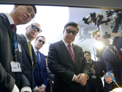 LONDON, ENGLAND - OCTOBER 21: Prince Andrew, Duke of York (second left), Chancellor George Osborne (third left) and Chinese President Xi Jinping (centre) wear 3D glasses to view robotic equipment with Phd student Gauthier Gras (left) in the Hamlyn Centre for Medical Robotics during a visit to Imperial College on …