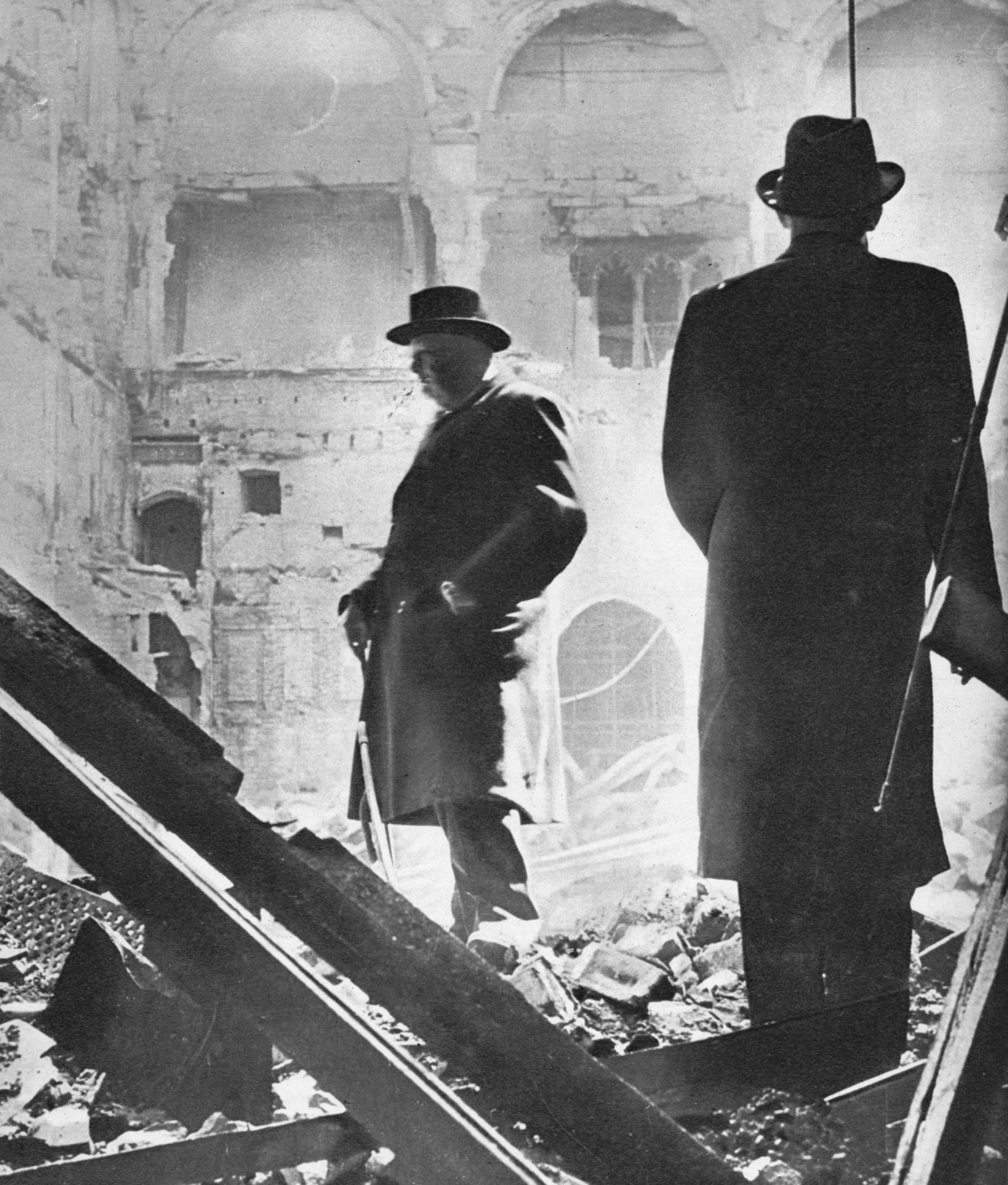 Mr. Churchill contemplates the ruins of the House of Commons, bombed in May 1941', 1941 (1955). Incendiary bombs which fell on the nights of 10 and 11 May 1941 caused the greatest damage to the Palace of Westminster and the Commons Chamber was entirely destroyed by fire. The Palace was damaged by air raids on fourteen different occasions during the war. From Churchill: The Man of the Century - A Pictorial Biography, edited by Neil Ferrier. [L.T.A. Robinson Limited, London, 1955]. Artist Unknown(Photo by The Print Collector/Getty Images)