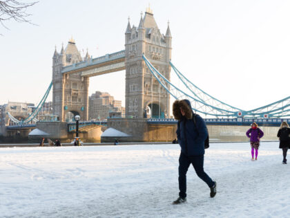 People walk to work on the south bank in front of Tower Bridge after snow has fallen overnight in London, England on February 28th, 2018. Freezing weather conditions dubbed the 'Beast from the East' have brought snow and sub-zero temperatures to the UK. (photo by Vickie Flores/In Pictures via Getty …