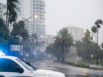 SARASOTA, FL - SEPTEMBER 28: A police officer drives by an empty street as Hurricane Ian approaches on September 28, 2022 in Sarasota, Florida. Forecasts call for the storm to make landfall today. (Sean Rayford/Getty Images)