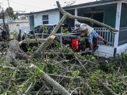 OPSHOT - A Resident of Tropical Park Mobile Homes cleans up debris from fallen trees in the aftermath of Hurricane Ian in Fort Myers, Florida, on September 29, 2022. - Hurricane Ian left a trail of devastation across Florida on Thursday with whole neighborhoods reduced to shattered ruins and millions …