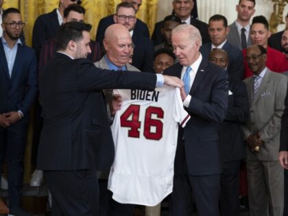 Atlanta Braves President and CEO Terry McGuirk, right, looks on as Braves President of Baseball Operations Alex Anthopoulos, left, and Braves manager Brian Snitker present a jersey to President Joe Biden during an event celebrating the 2021 World Series champion Atlanta Braves, in the East Room of the White House, …