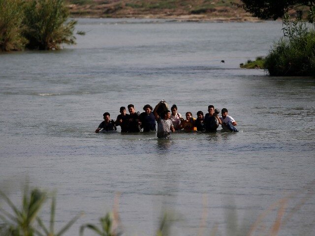 Migrants, mostly from Nicaragua, cross the Rio Grande River into the U.S., in Eagle Pass,