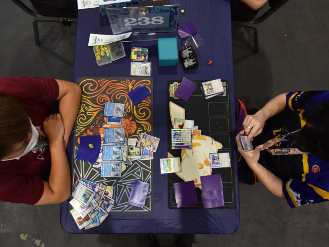 Competitors play Pokemon cards during the 2022 Pokémon World Championships at ExCel on Au