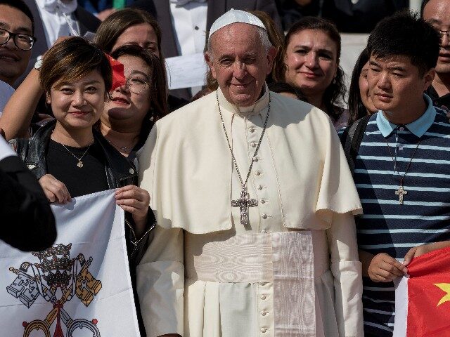 Pope Francis poses for a photo with a group of pilgrims from China during his weekly general audience in St. Peter's Square at the Vatican, Wednesday, Oct. 2, 2019. (Photo by Massimo Valicchia/NurPhoto via Getty Images)