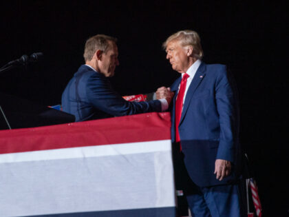 WILMINGTON, NC - SEPTEMBER 23: Representative Ted Budd shakes hands with former President Donald Trump at a Save America Rally at the Aero Center Wilmington on September 23, 2022 in Wilmington, North Carolina. The "Save America" rally was a continuation of Donald Trump's effort to advance the Republican agenda by …