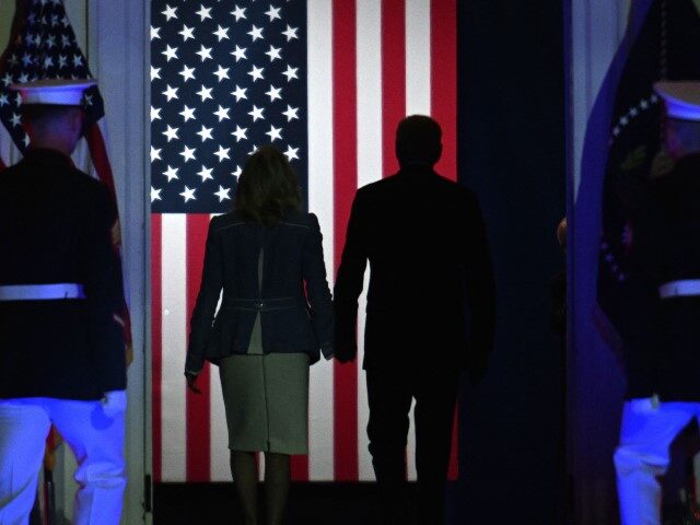 President Joe Biden and First Lady Jill Biden walk away after he delivered a speech about