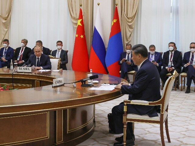 Chinese President Xi Jinping, right, and Russian President Vladimir Putin attend a trilateral meeting with Mongolian President Ukhnaa Khurelsukh on the sidelines of the Shanghai Cooperation Organisation (SCO) summit in Samarkand, Uzbekistan, Thursday, Sept. 15, 2022. (Alexandr Demyanchuk, Sputnik, Kremlin Pool Photo via AP)