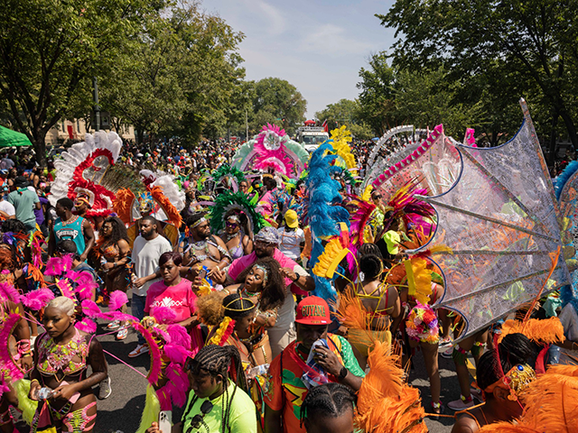 Participants in costume walk during the West Indian Day Parade, Monday, Sept. 5, 2022, in