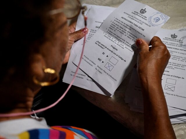 A member of the electoral authorities counts ballots at a polling station in Havana, on Se