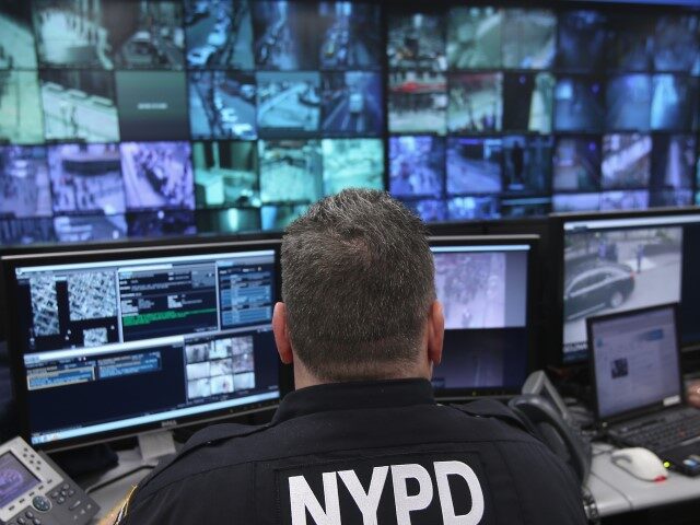 Police and private security personel monitor security cameras at the Lower Manhattan Secur